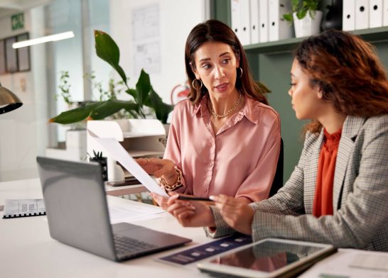 Office, discussion and financial advisor with client for paperwork, investment planning or tips. Business meeting, women or conversation with policy for insurance advice, guidance or corporate report